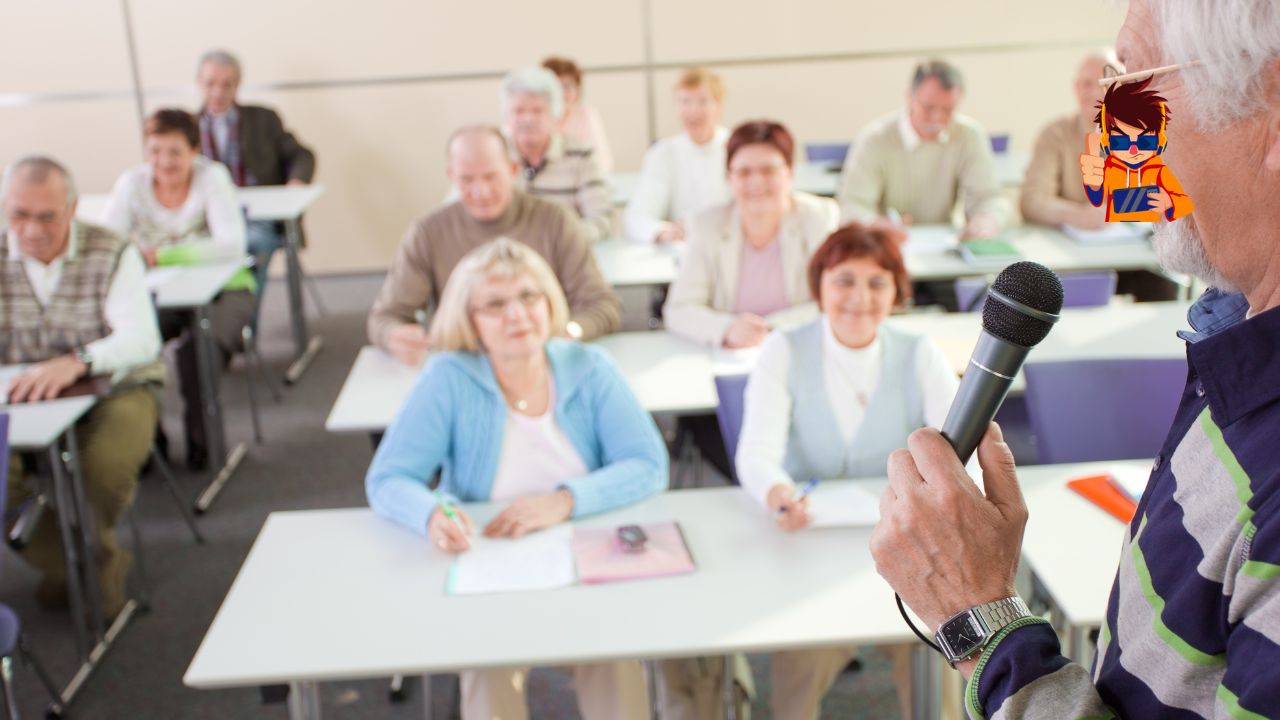 The Power of Lifelong Learning Why It’s Never Too Late to Start An older adult speaking into a microphone in a classroom setting, addressing a group of senior learners seated at desks with notebooks and pens. The image conveys the concept of lifelong learning and emphasizes that education is accessible at any age.